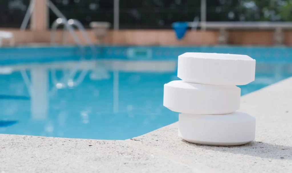 Drop chlorine tablets into the pool